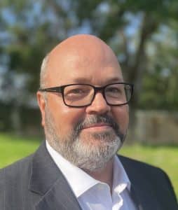 a man wearing a suit and sun glasses