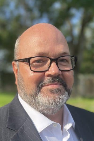 a man wearing a suit and sun glasses