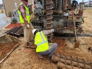 a pile of dirt in front of a building
