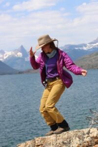 a person standing next to a body of water