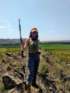 a person standing on top of a grass covered field