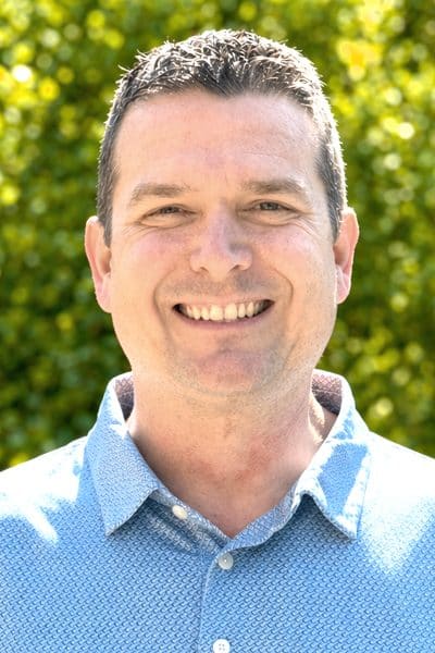 a man smiling at the camera